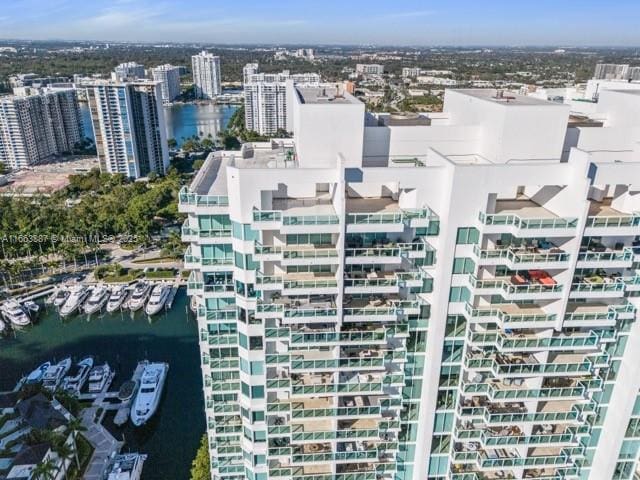 birds eye view of property featuring a view of city and a water view