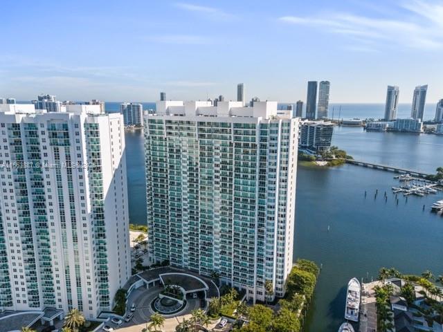 birds eye view of property with a view of city and a water view