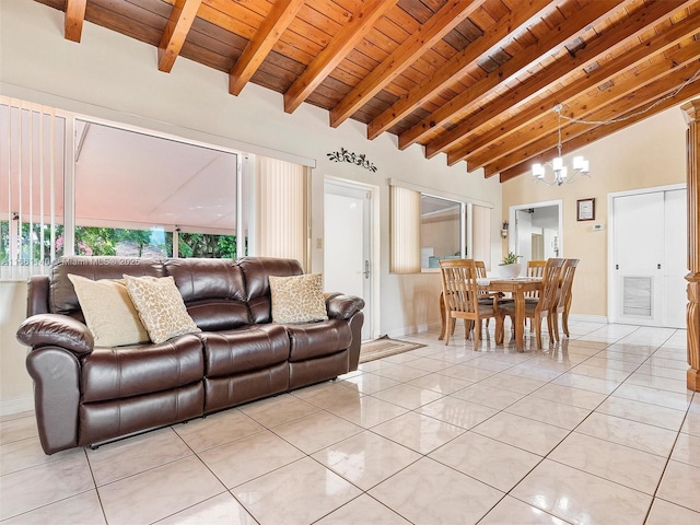 living room featuring light tile patterned flooring, beamed ceiling, an inviting chandelier, and wooden ceiling