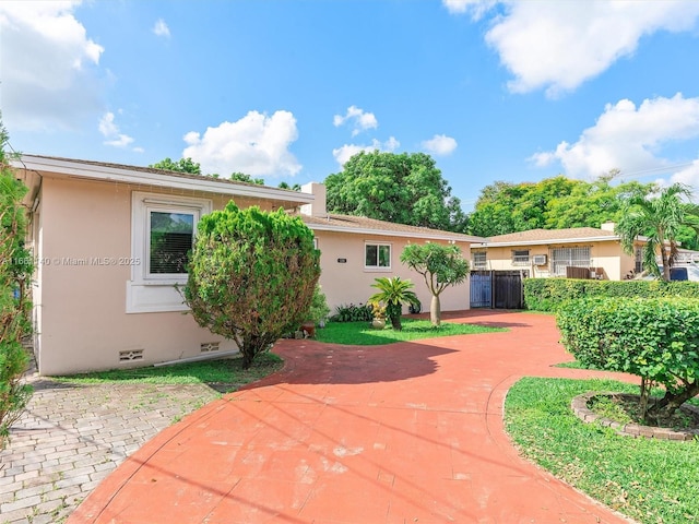 2380 SW 7th St, Miami, FL 33135 - view of front of house featuring stucco siding, crawl space, and a patio