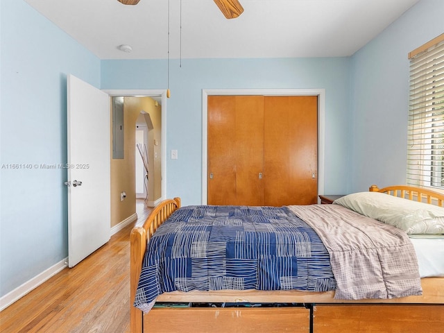 bedroom with light hardwood / wood-style flooring and ceiling fan