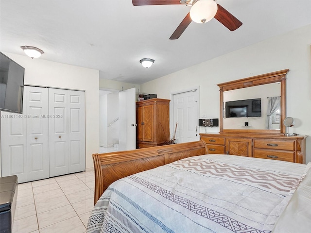 bedroom with ceiling fan, a closet, and light tile patterned floors