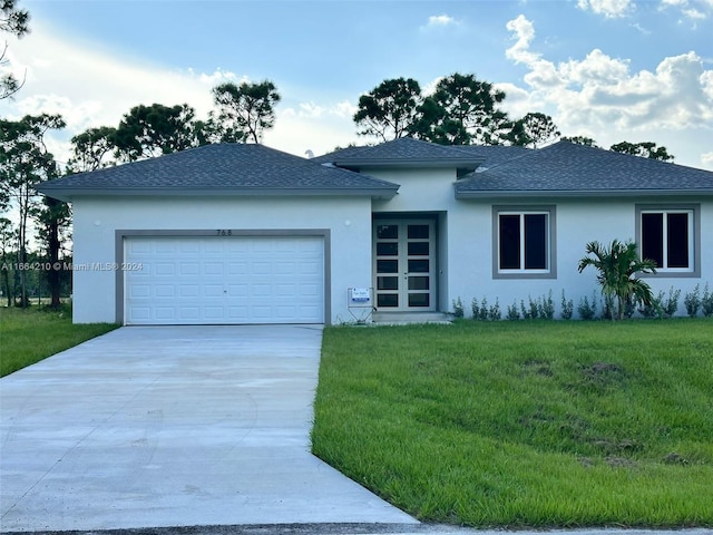 view of front of property with a front yard and a garage