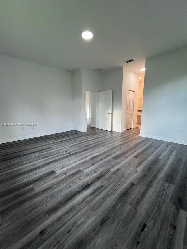 empty room with dark hardwood / wood-style floors