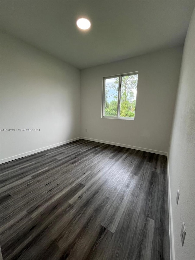 spare room featuring dark hardwood / wood-style flooring