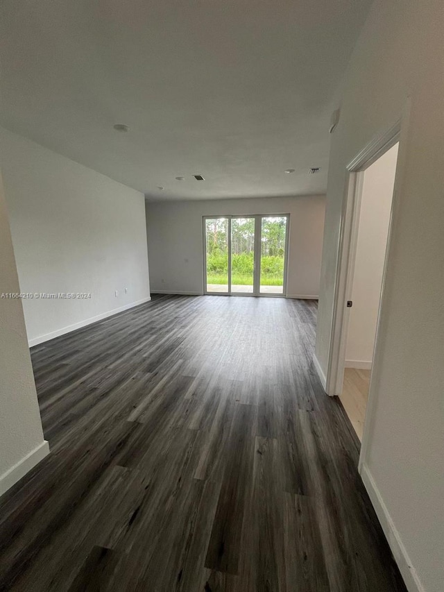 empty room featuring dark wood-type flooring