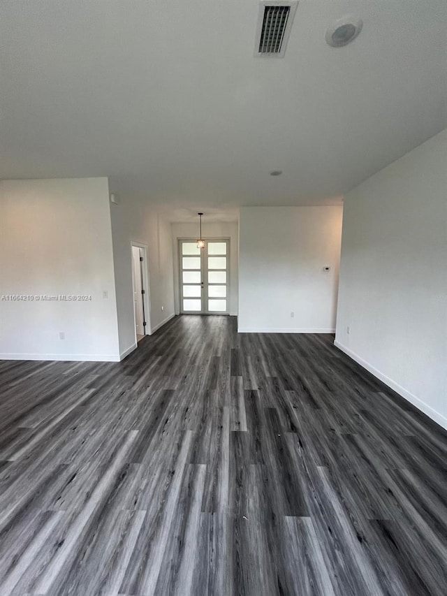 empty room with dark wood-type flooring