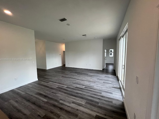 spare room featuring dark hardwood / wood-style floors