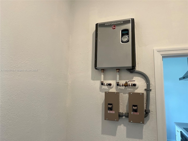 utility room featuring water heater