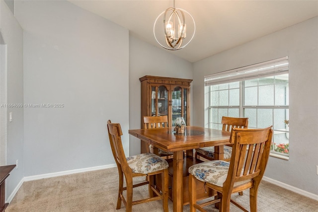 dining space with vaulted ceiling, light colored carpet, and a chandelier