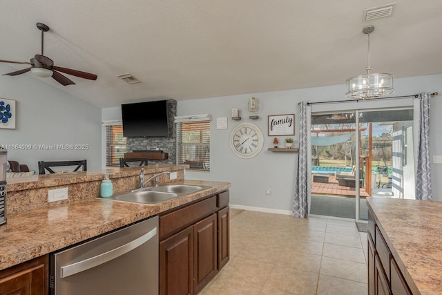 kitchen with lofted ceiling, sink, hanging light fixtures, ceiling fan with notable chandelier, and stainless steel dishwasher