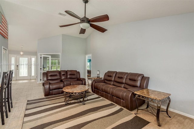 carpeted living room featuring ceiling fan and high vaulted ceiling