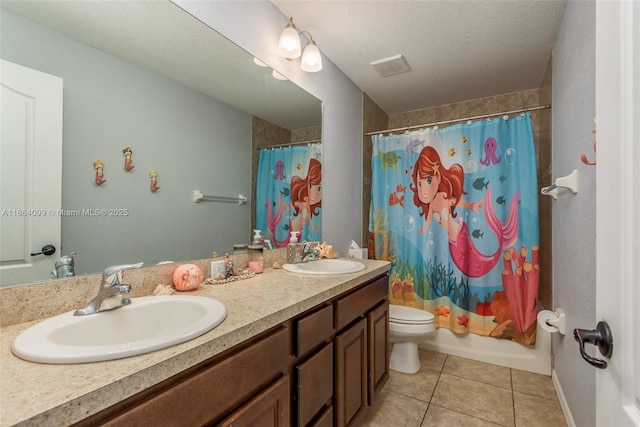 full bathroom featuring shower / tub combo with curtain, tile patterned flooring, vanity, a textured ceiling, and toilet