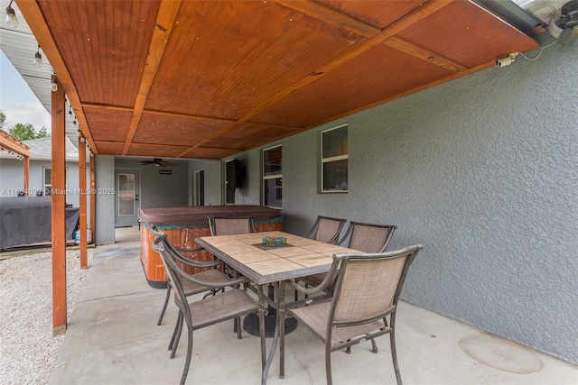 view of patio featuring a hot tub and ceiling fan