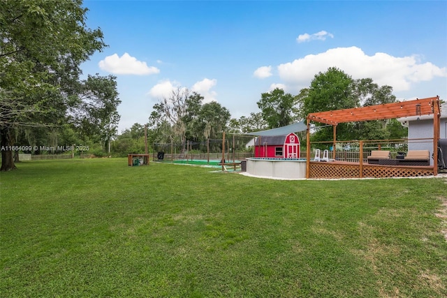 view of yard with a pool side deck and a pergola