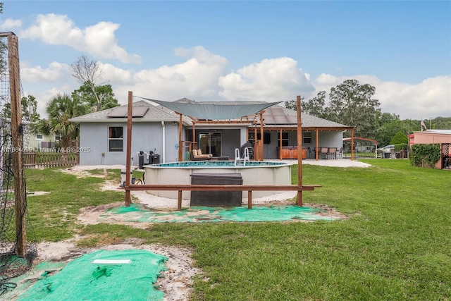 back of property featuring a yard and an outdoor bar