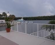 view of patio / terrace with a balcony and a water view