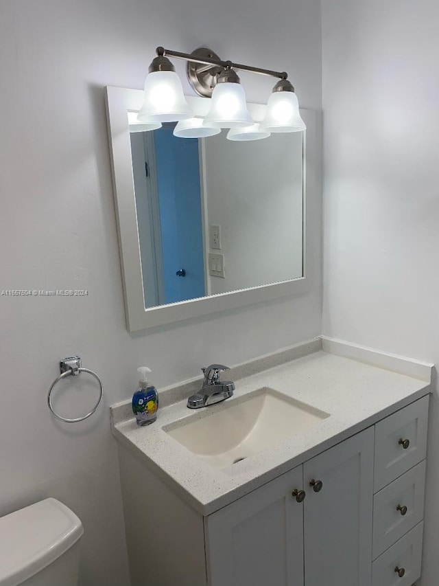 bathroom with toilet and vanity