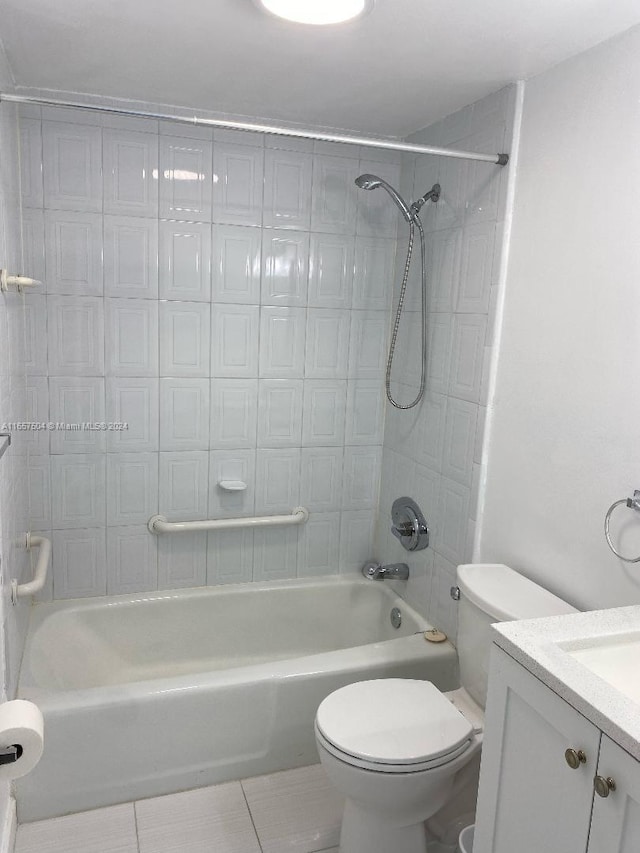 full bathroom featuring tile patterned flooring, vanity, toilet, and tiled shower / bath