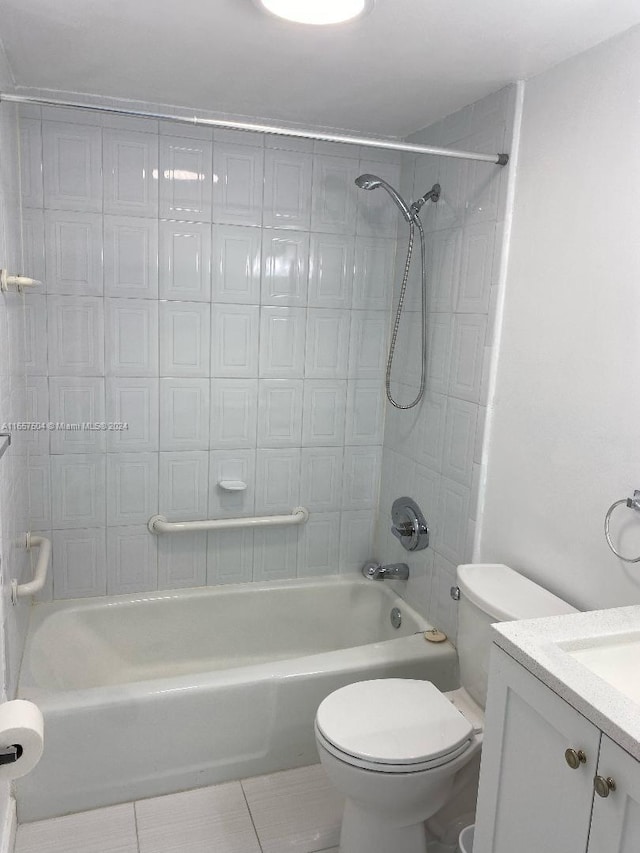 bathroom with toilet, tile patterned flooring, shower / washtub combination, and vanity