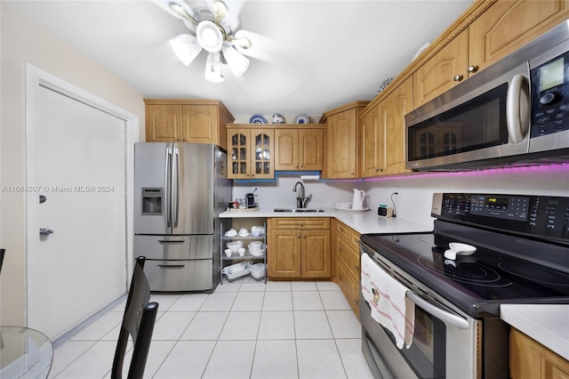 kitchen featuring light tile patterned floors, sink, ceiling fan, and stainless steel appliances