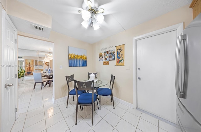 dining space with ceiling fan and light tile patterned floors