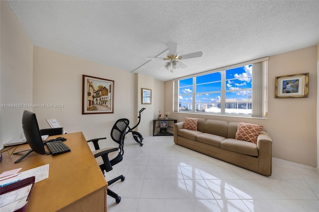 tiled office featuring ceiling fan and a textured ceiling