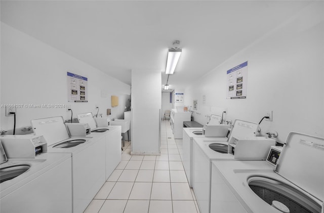 laundry room featuring washing machine and dryer and light tile patterned flooring