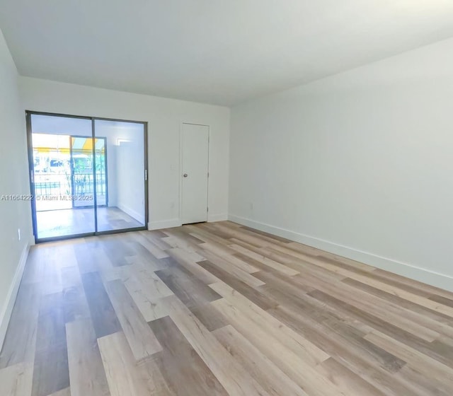 unfurnished room with light hardwood / wood-style flooring