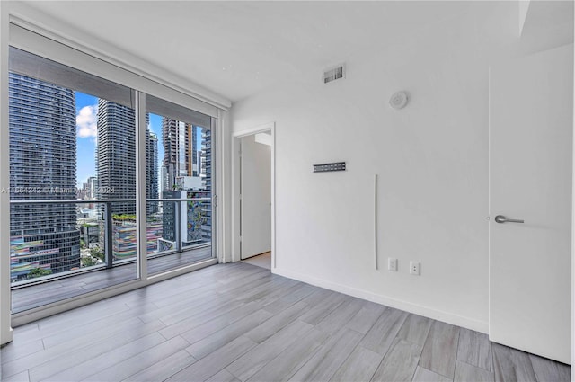 spare room with light hardwood / wood-style flooring