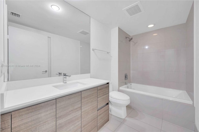 full bathroom featuring tiled shower / bath combo, vanity, toilet, and tile patterned floors