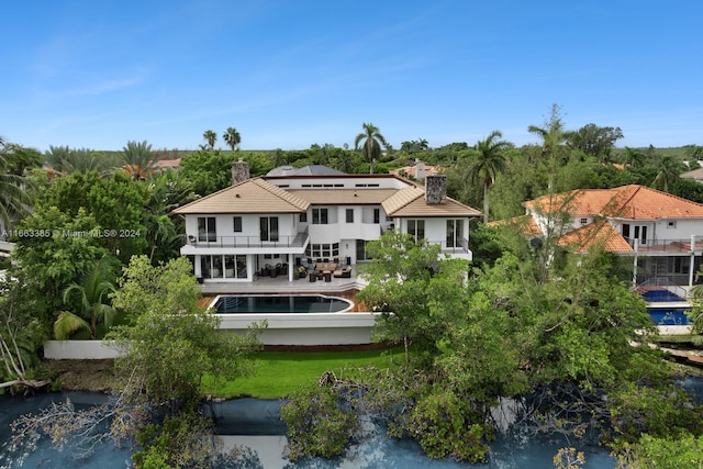 325 Campana Ave, Coral Gables, FL 33156 - back of property with a balcony, a chimney, and an outdoor pool