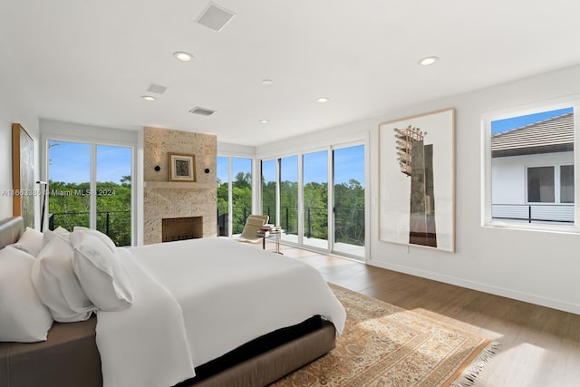 325 Campana Ave, Coral Gables, FL 33156 - bedroom featuring access to exterior, wood finished floors, a large fireplace, recessed lighting, and baseboards