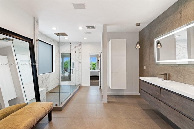 325 Campana Ave, Coral Gables, FL 33156 - bathroom with a marble finish shower, vanity, finished concrete flooring, baseboards, and recessed lighting