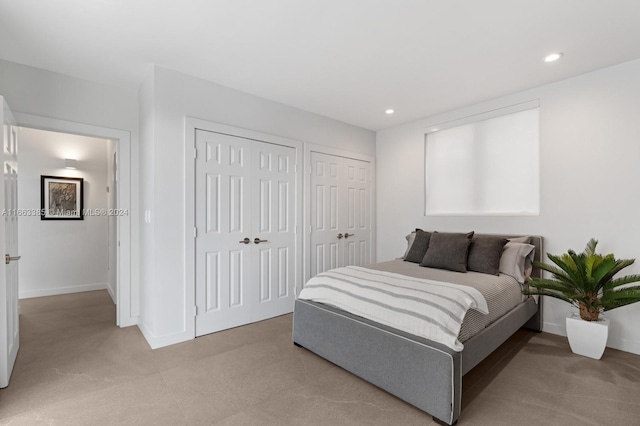 325 Campana Ave, Coral Gables, FL 33156 - bedroom with two closets, light carpet, baseboards, and recessed lighting