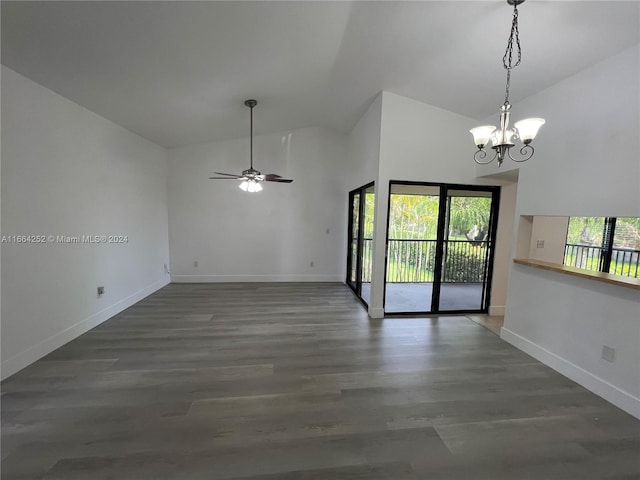 empty room with ceiling fan with notable chandelier, dark wood-type flooring, and high vaulted ceiling