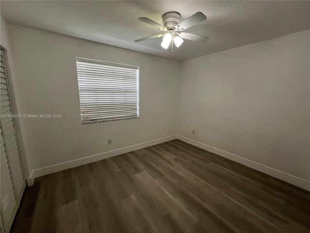 spare room featuring a textured ceiling, dark hardwood / wood-style flooring, and ceiling fan