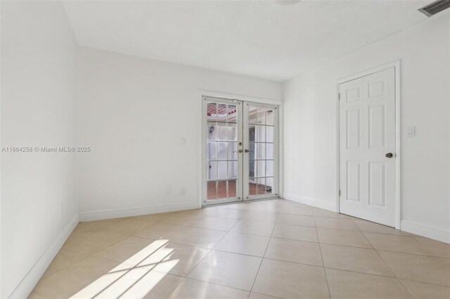 foyer entrance featuring a textured ceiling and light tile patterned floors