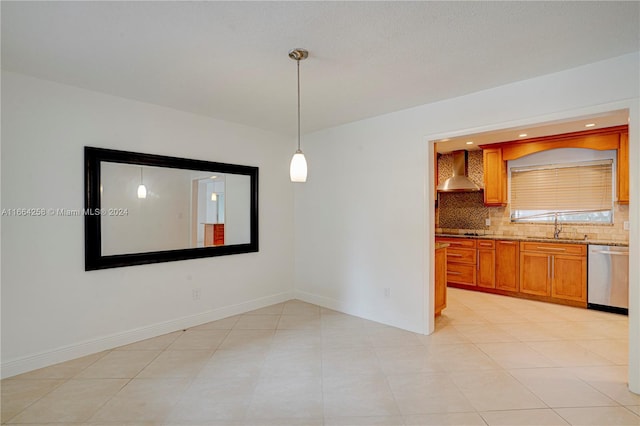 unfurnished dining area with sink and light tile patterned flooring