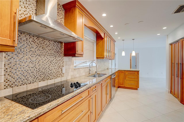 kitchen with wall chimney range hood, decorative backsplash, black electric cooktop, dishwasher, and sink