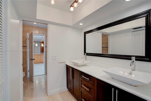 bathroom featuring vanity, toilet, and tile patterned floors