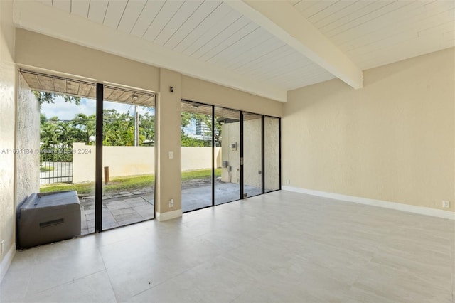 spare room featuring beamed ceiling and wooden ceiling