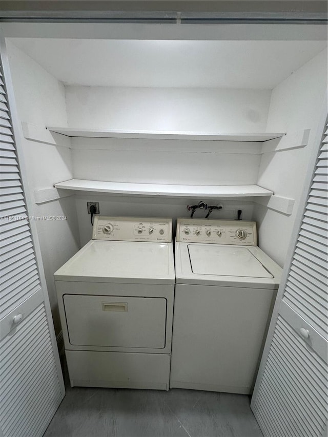 clothes washing area featuring washing machine and clothes dryer and hardwood / wood-style floors