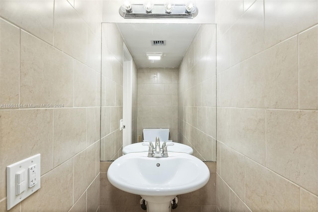 bathroom with tile walls and sink