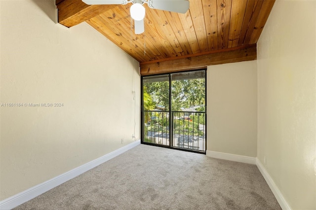 spare room featuring beam ceiling, wooden ceiling, ceiling fan, and carpet floors