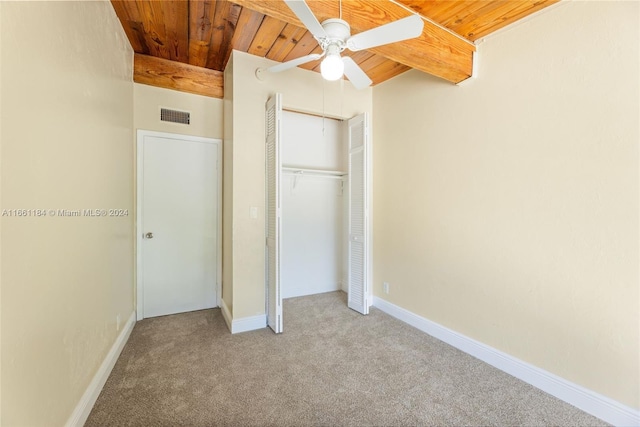 unfurnished bedroom with light carpet, ceiling fan, wooden ceiling, and a closet