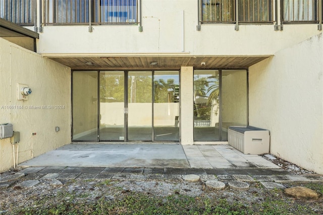 property entrance with a balcony and a patio area