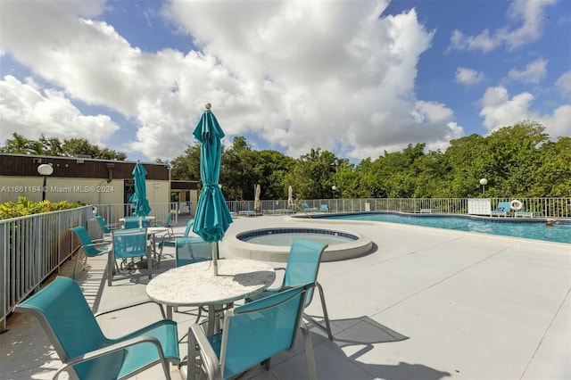 view of pool with a patio and a community hot tub