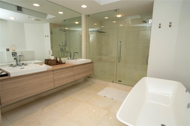 bathroom with tile patterned flooring, vanity, toilet, and a shower with shower door