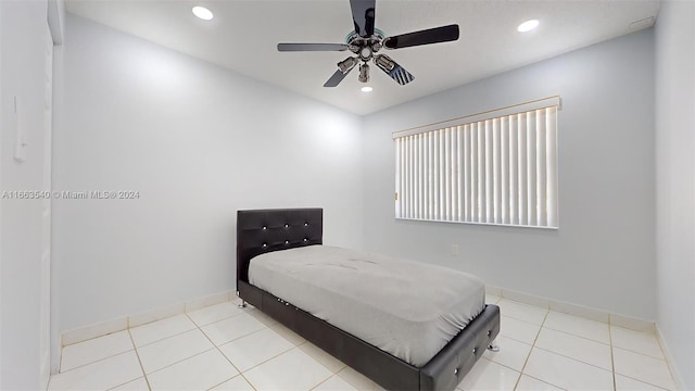 bedroom with ceiling fan and light tile patterned flooring